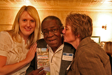 Minnie Mi&ntilde;oso holding Sports Traveler Chicago book at launch event