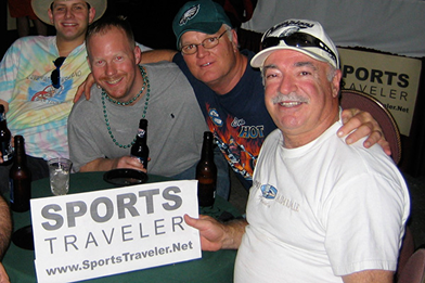 Fans holding original Sports Traveler sign during first tour