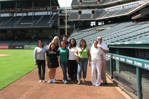 Travel agents standing on baseball field during sports travel familiarization tour