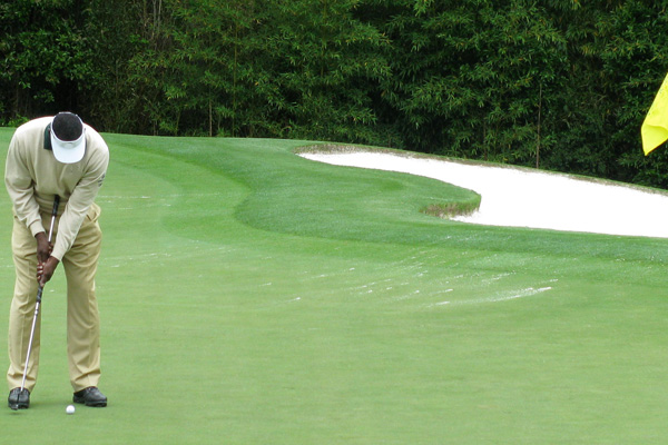 Player sinks a putt a the Masters Golf Tournament