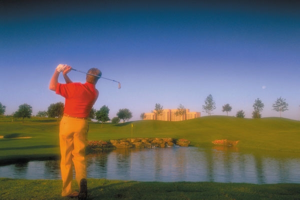 Golfer teeing off at the TPC Las Colinas Texas Resort